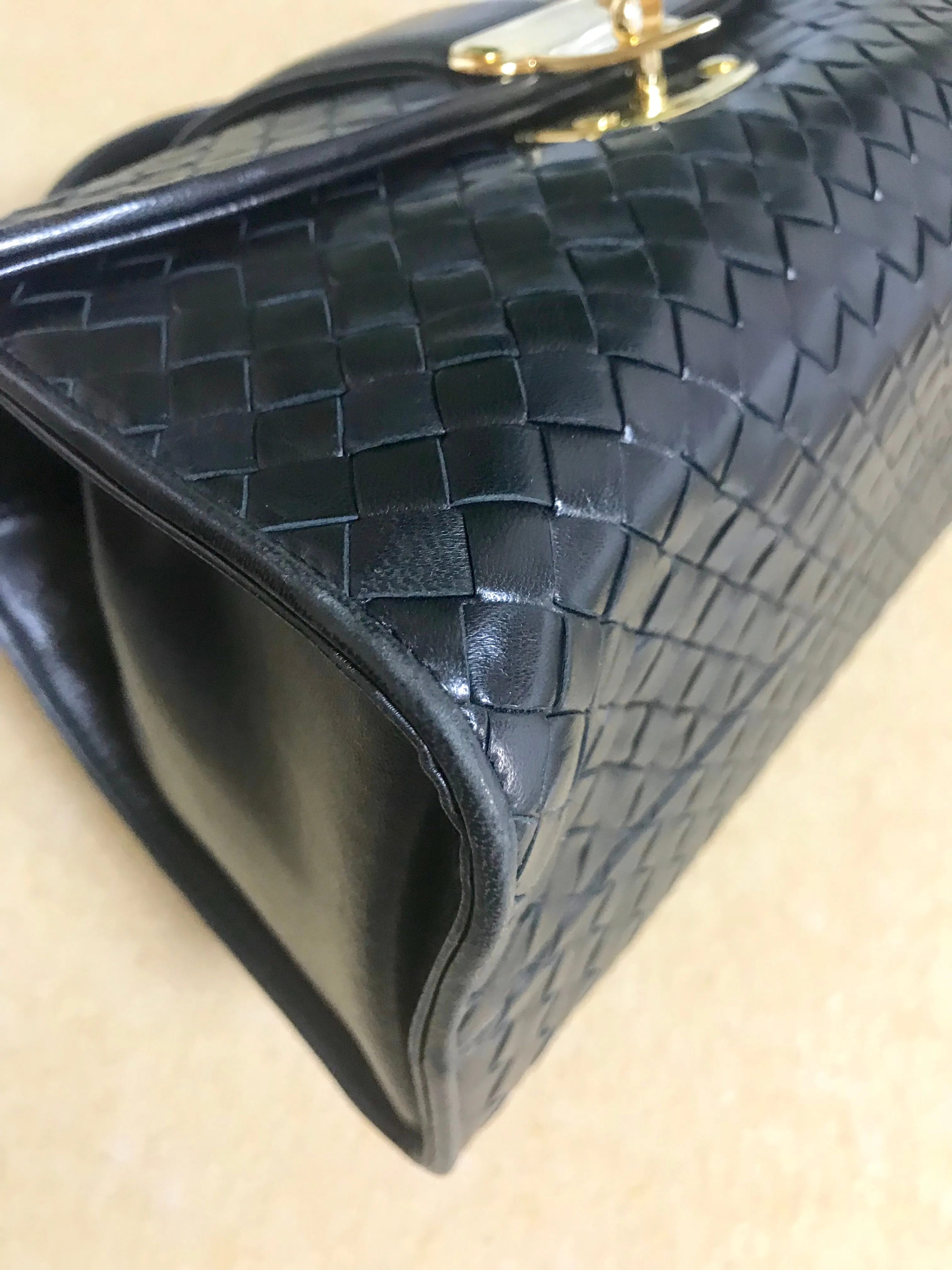 1990s. Vintage Bottega Veneta classic black lamb leather intrecciato handbag with golden closure hock. Gorgeous masterpiece from Bottega.